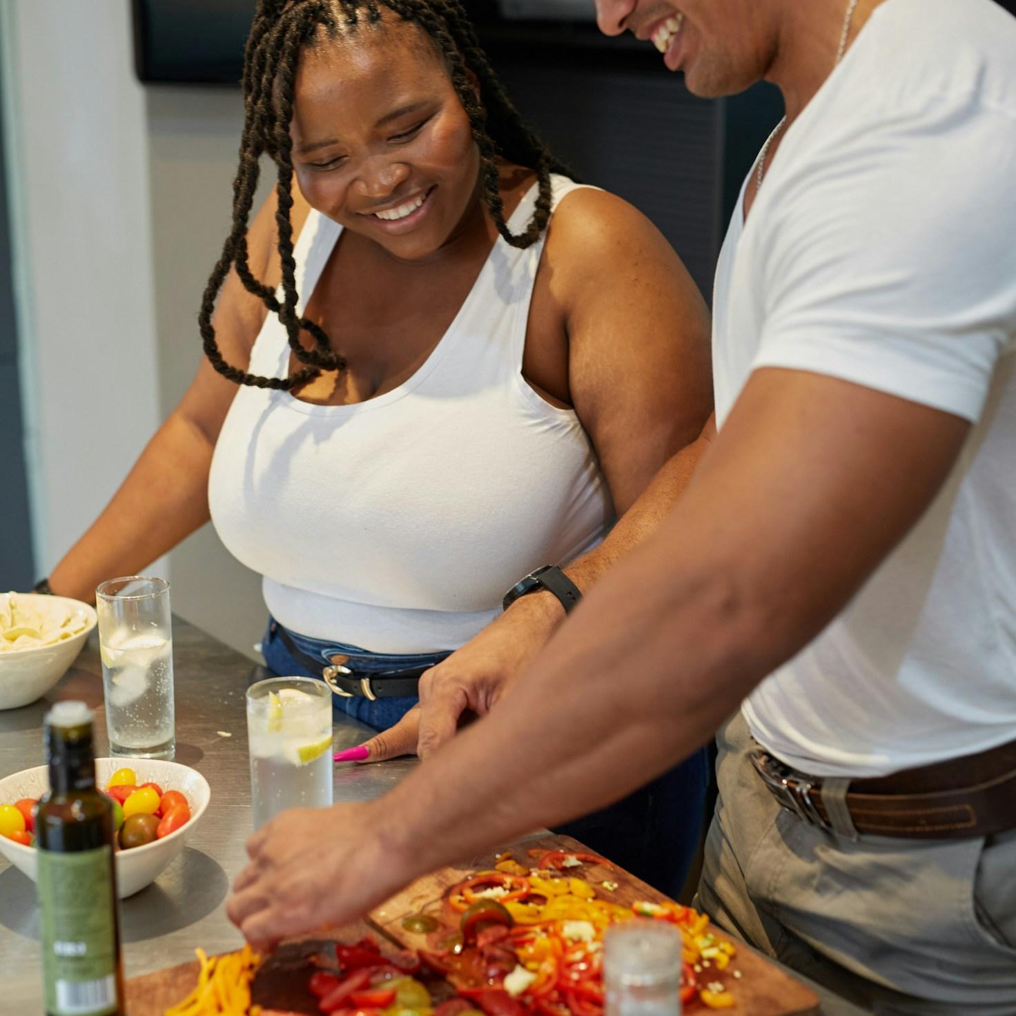Community members collaborating in a modern kitchen space, sharing recipes and cooking techniques