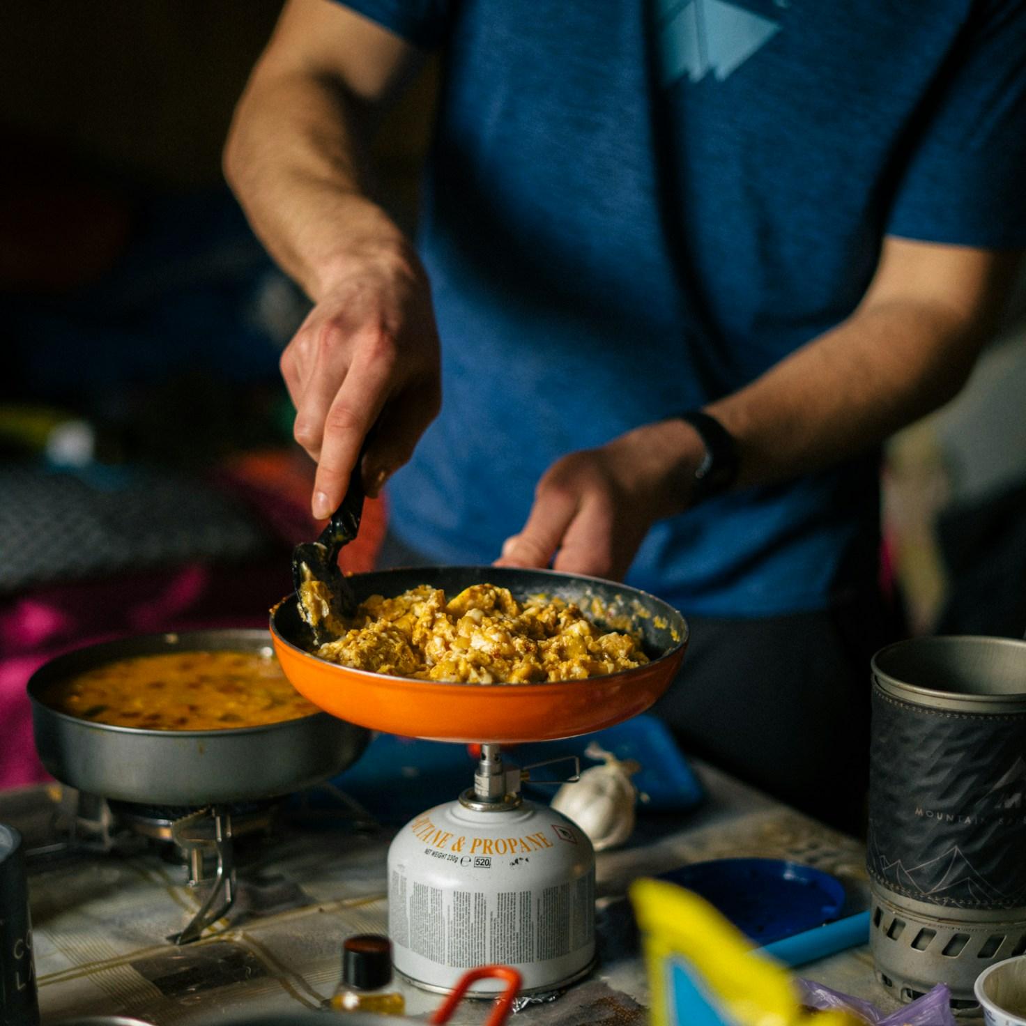 Diverse group of community members sharing a meal together, showcasing the social bonds formed through collaborative cooking